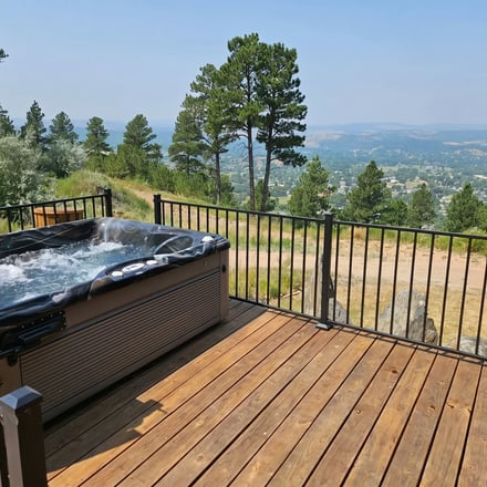 Hot tub overlooking Black Hills pine forest at sunset